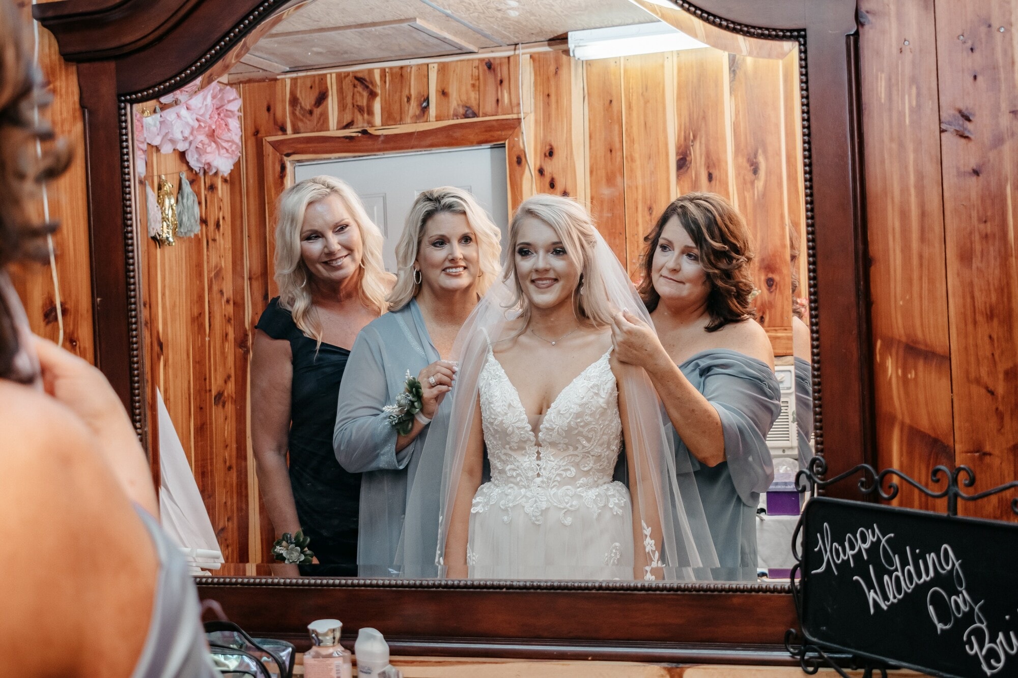 Bride and her family looking at her in the mirror | The Color of Love