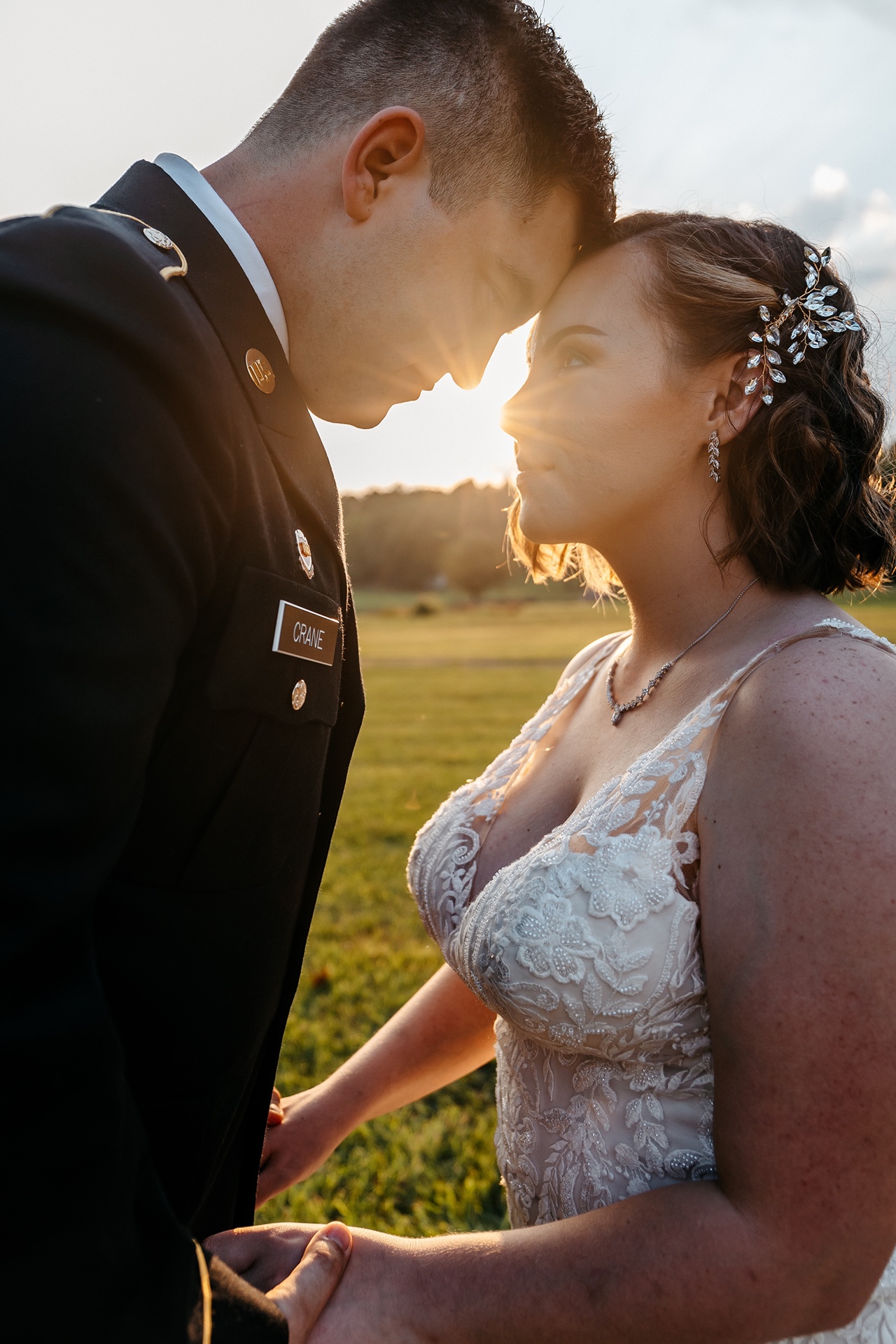 A bride and groom touch forheads as a sunbeam shines through at one of the best outdoor wedding venues in georgia on a budget