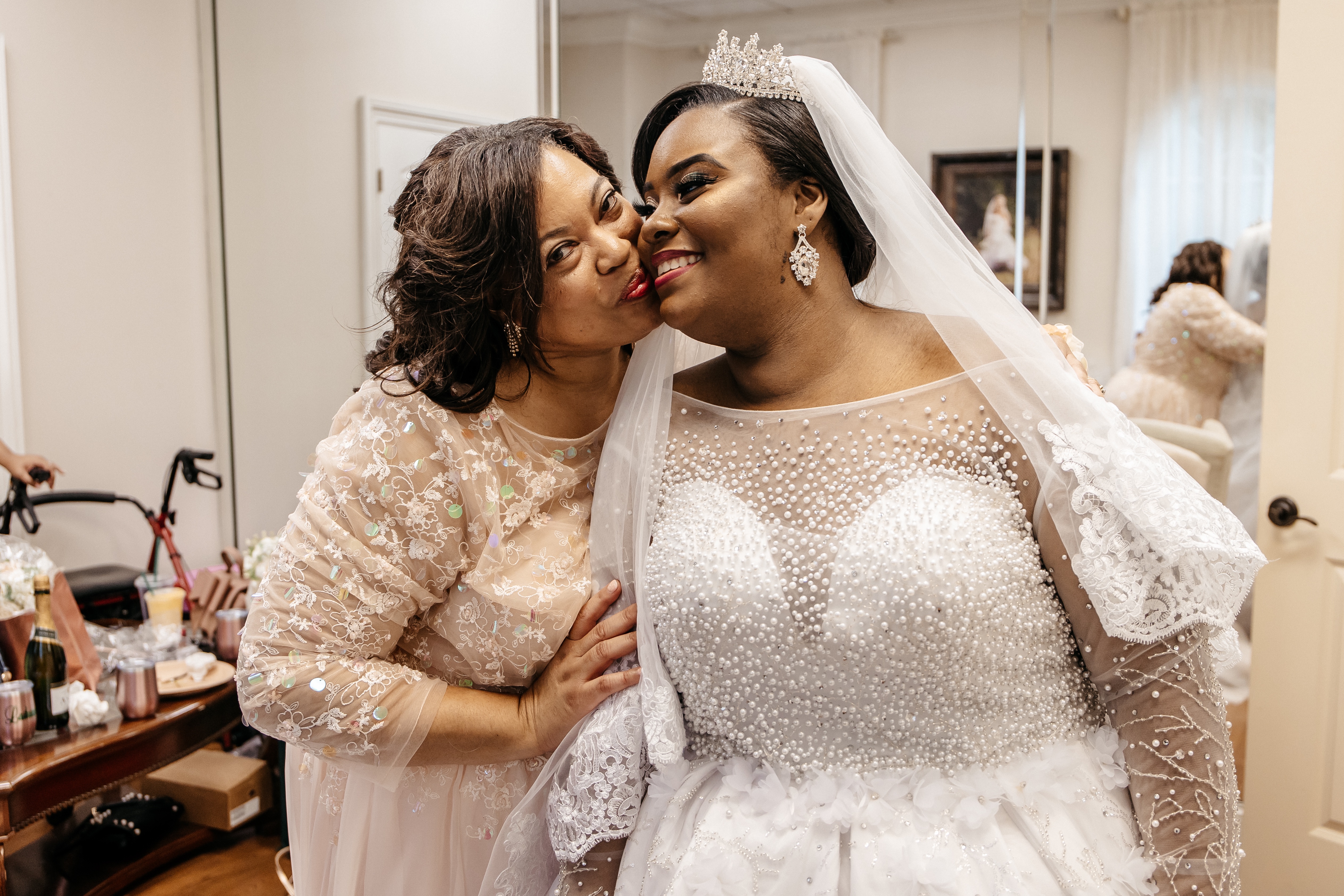 A bride receives a kiss from her mother after getting ready for her
​micro wedding in north georgia
