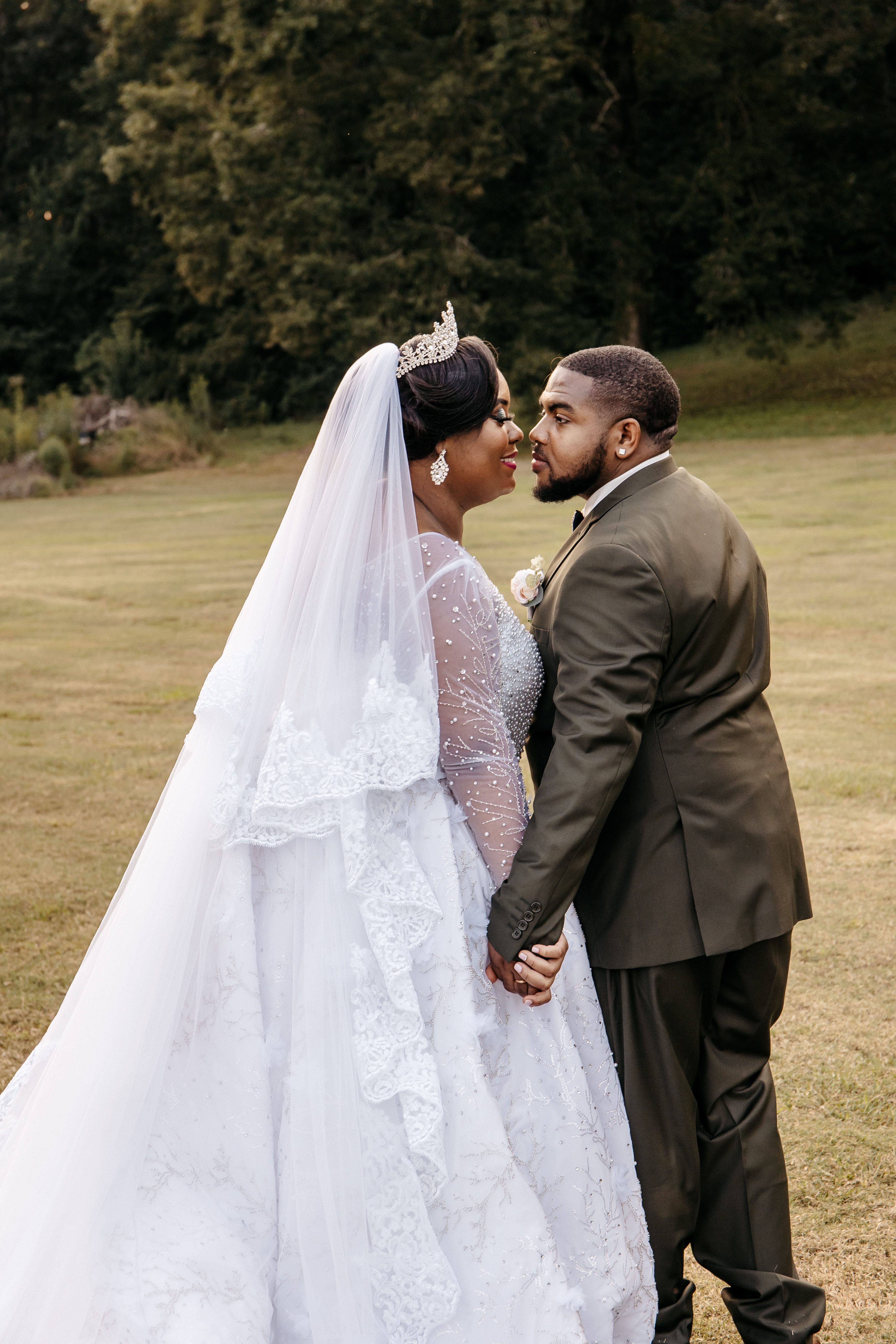 A bride and groom stand in a field and kiss after their ​micro wedding ceremony in north georgia