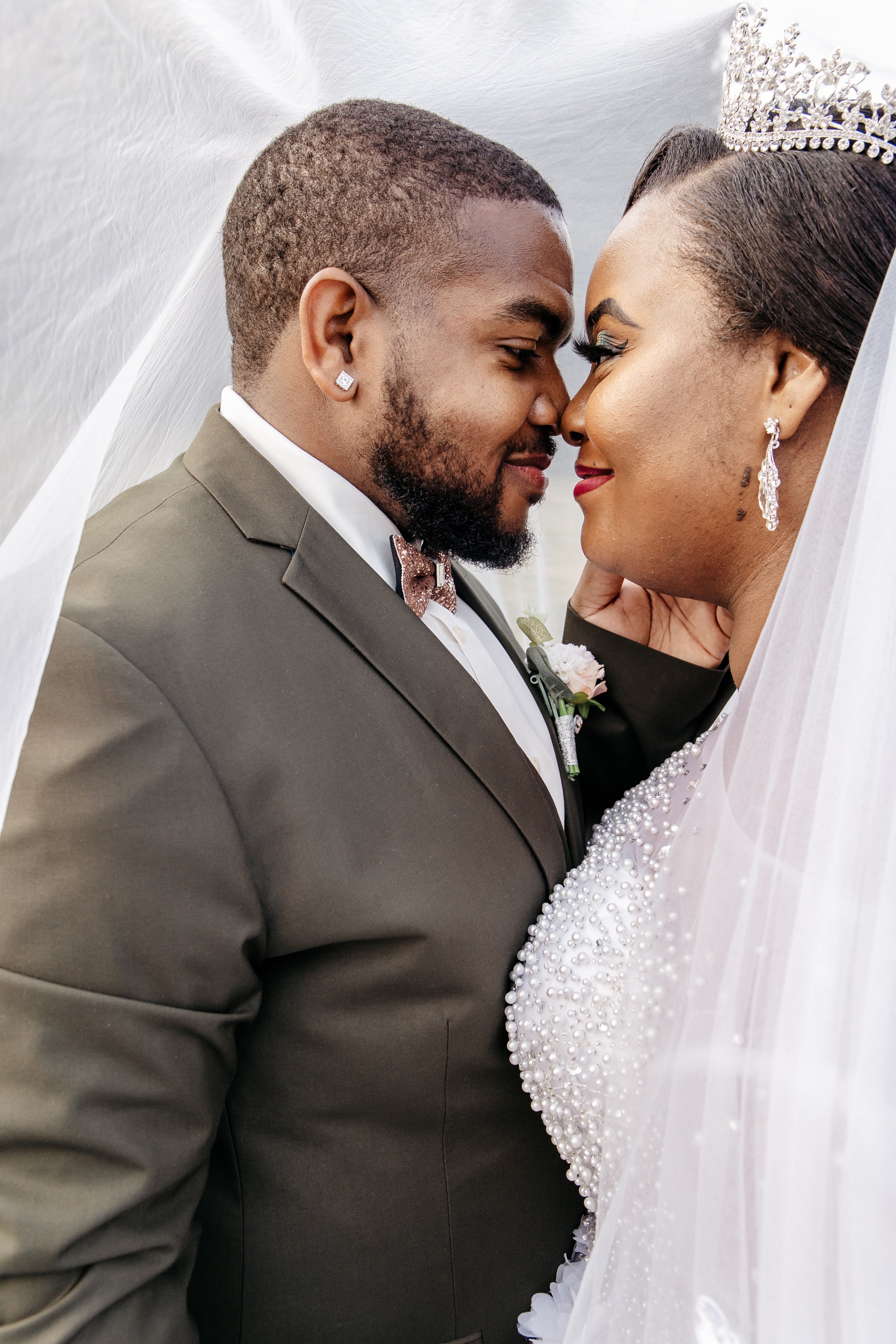 A groom holds his bride's face and smiles before their micro wedding in georgia
